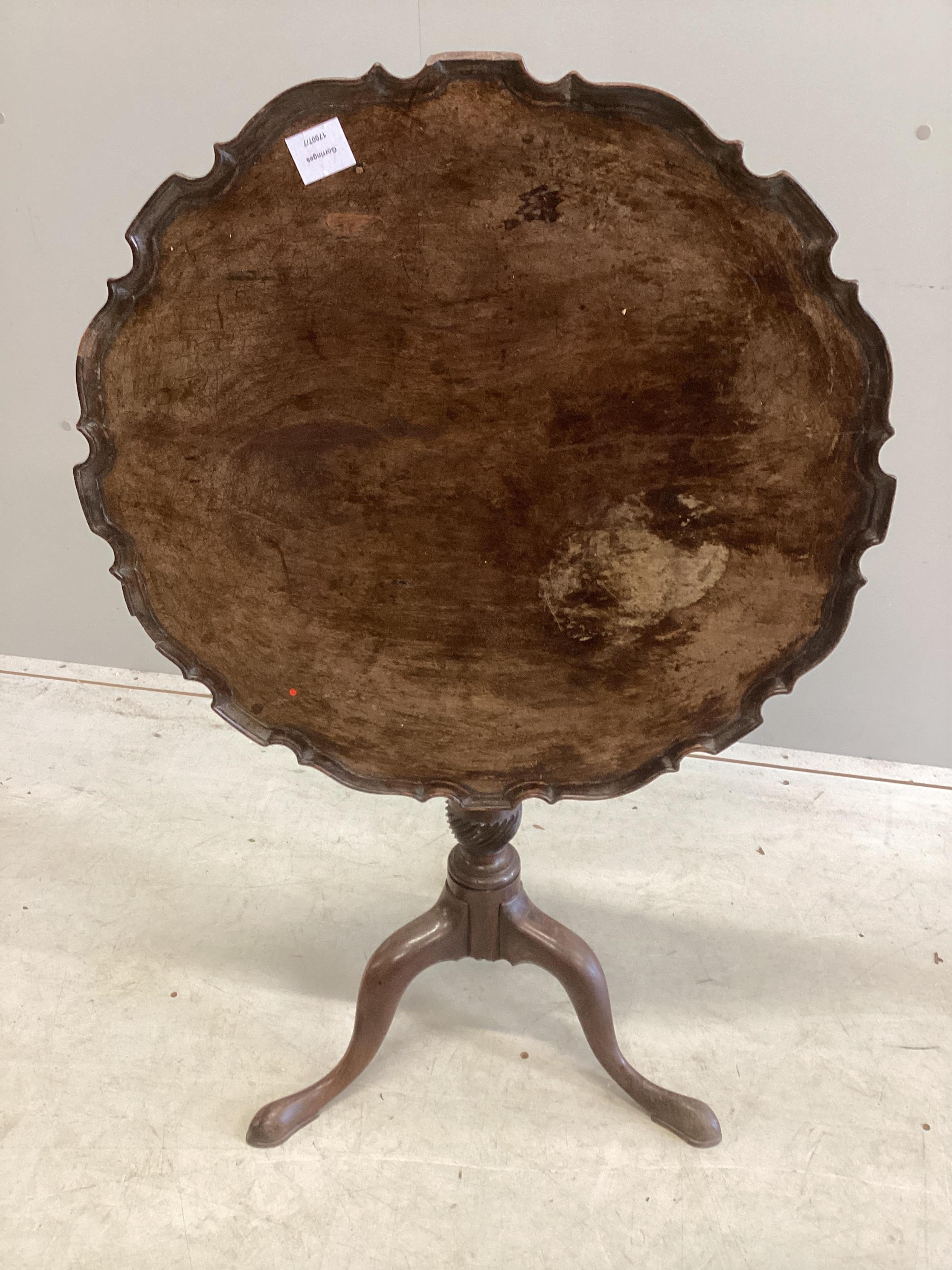 A George III circular mahogany piecrust tilt top tripod tea table, diameter 66cm, height 69cm. Condition - poor